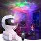 Astronaut Galaxy Projector projecting colorful nebula effects while child plays with a bike in a cozy room.