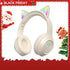 Cat Ear Bluetooth Headphones – LED Foldable Over-Ear design in festive setting with Santa and Christmas decorations.