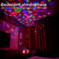 LED Starry Sky Projector creating a colorful starry sky atmosphere in a cozy bedroom.