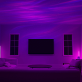 Aurora Northern Lights Projector creating a colorful purple light display on the ceiling of a modern living room.