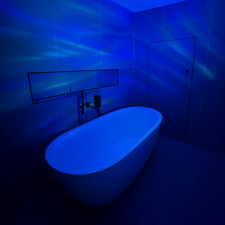 Aurora Northern Lights Projector creating a calming blue ambiance in a modern bathroom setting.