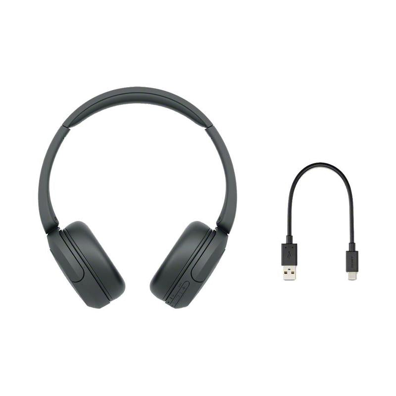 Sony Bluetooth headphones next to laptop for work setup