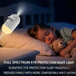  A young child sleeping soundly under a full-spectrum eye protection warm ambient bedside lamp.