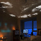 Moving star projector slide casting realistic night clouds and tree silhouettes across a modern bedroom ceiling. 